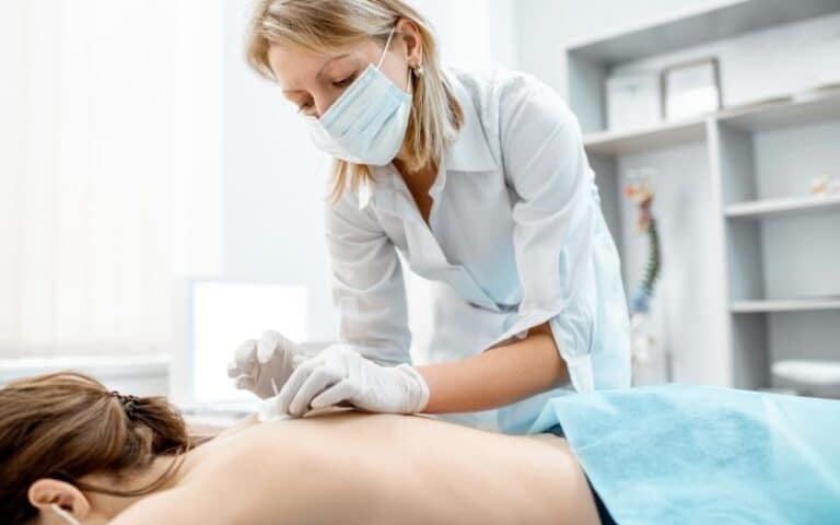 female acupuncturist treating female client
