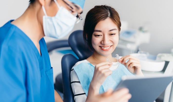dentist showing patient tmj splint