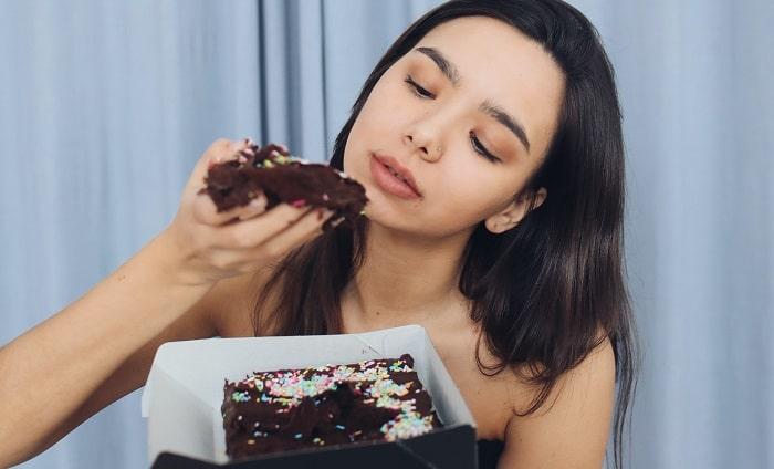 woman eating brownie