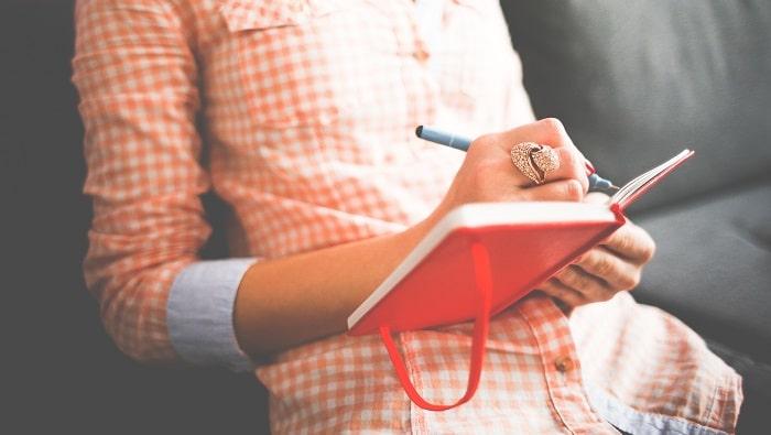 woman writing in journal