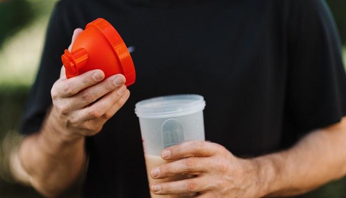 man with weight gainer shake in hand