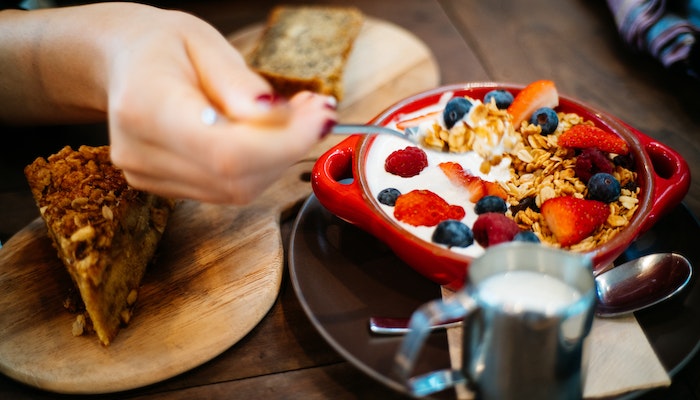 eating bowl of oatmeal at breakfast table