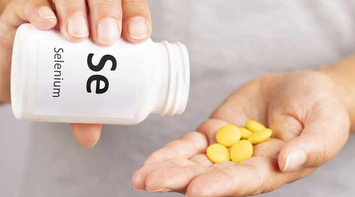 pouring selenium supplement into hand