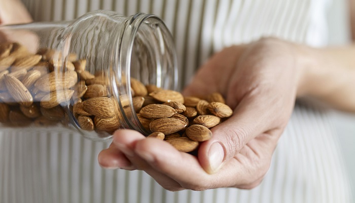 pouring almonds out of jar into hand