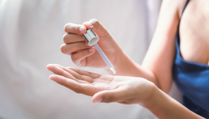 Woman applying essential oil