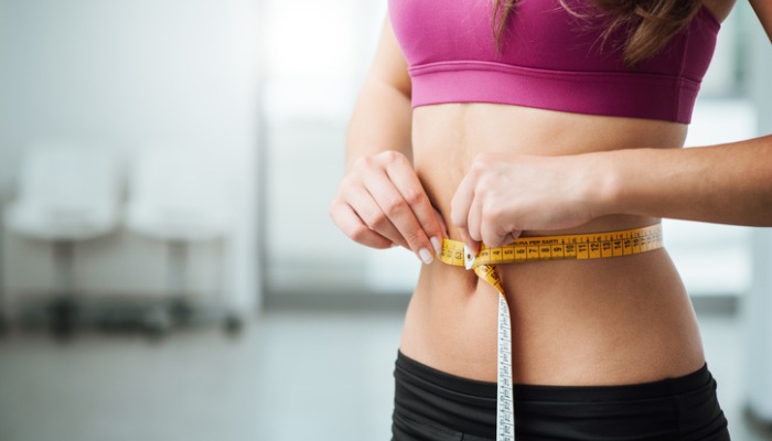 woman measuring waist - a body shape index