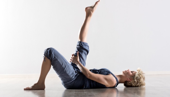 Woman on back stretching hamstring