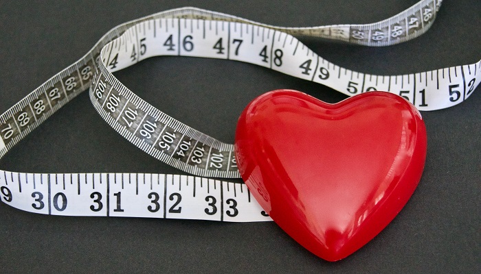 flexible measuring tape next to heart-shaped ball