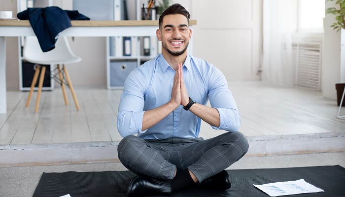 young businessman taking a break from work to meditate