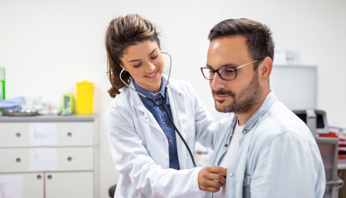 doctor listening to patient's heartbeat