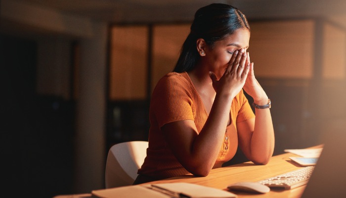 stressed-out businesswoman with hands on face
