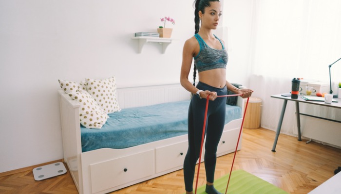 woman doing curls with resistance band