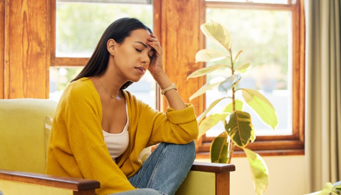 overwhelmed woman with hand on forehead