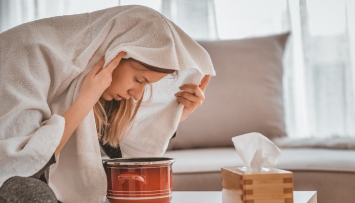 woman inhaling steam from essential oils for sinus infection