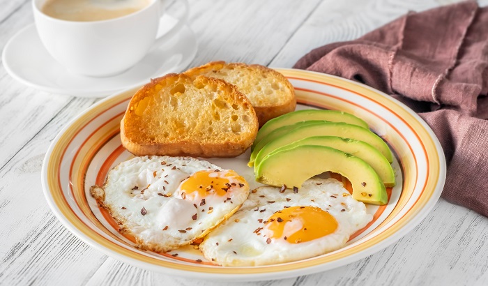 fried eggs with avocado and toast