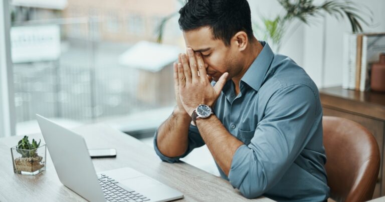 man covering face - stress tolerance concept