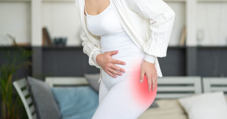 woman holding inflamed hip