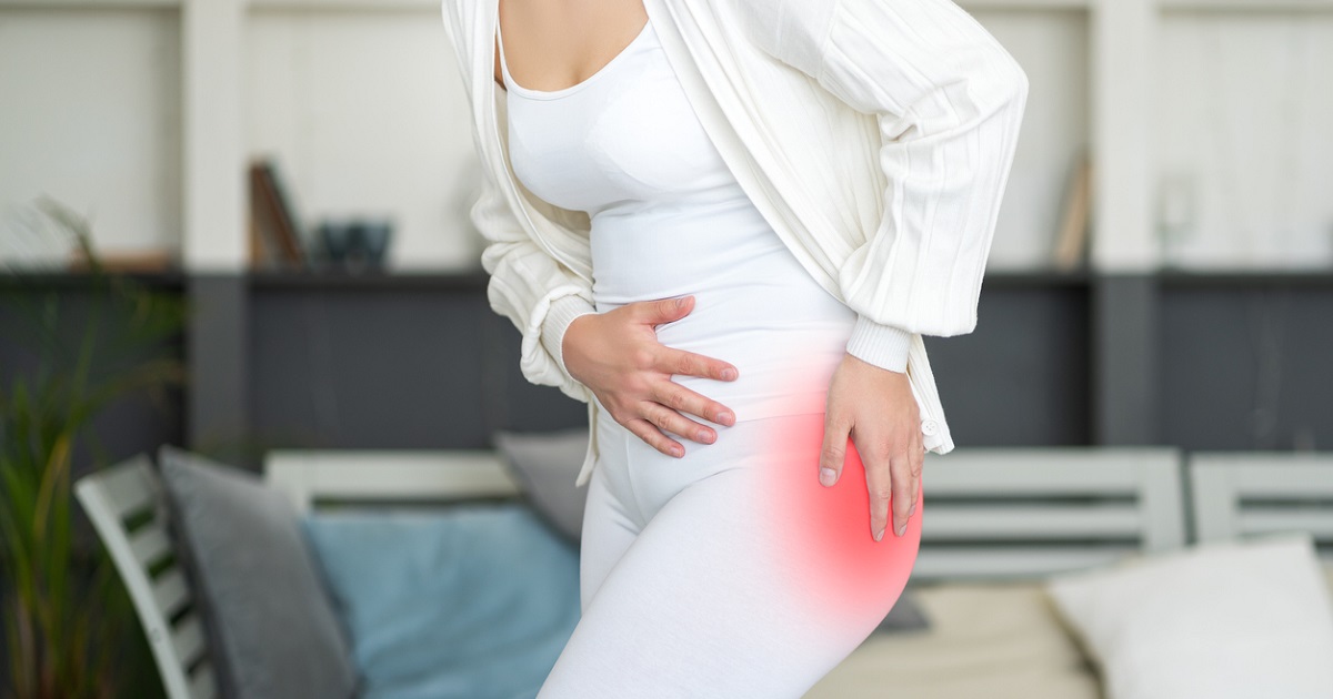 woman holding inflamed hip