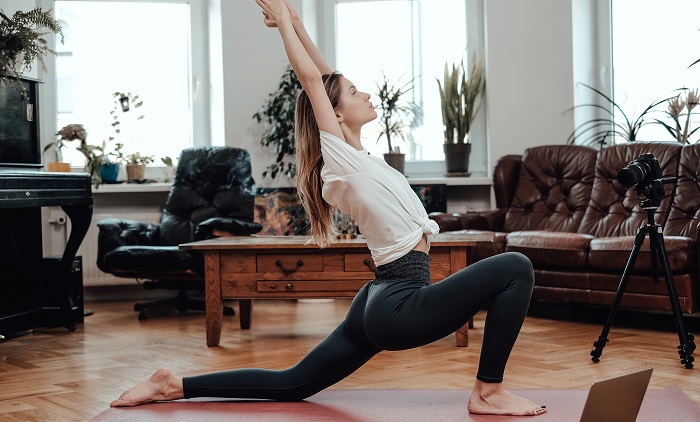 young woman doing yoga pose at home