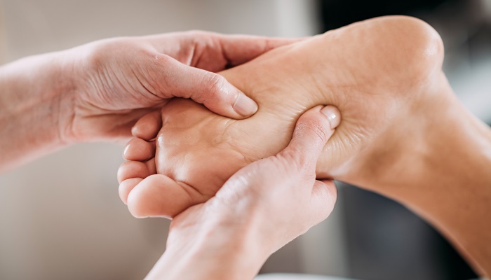 practitioner stimulating acupoints on foot