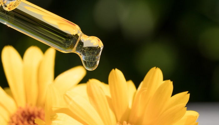 calendula flowers and essential oil dropper